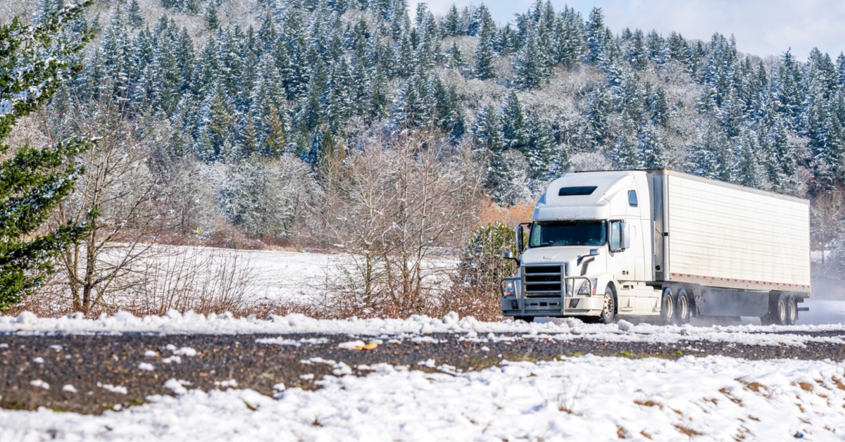 Semi-truck hauling dry goods on a snowy winter day with freight freeze protection in place